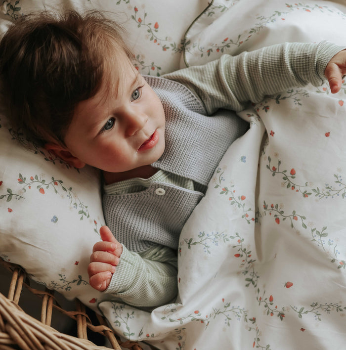 Botanical Berries Baby Duvet with boy laying with it