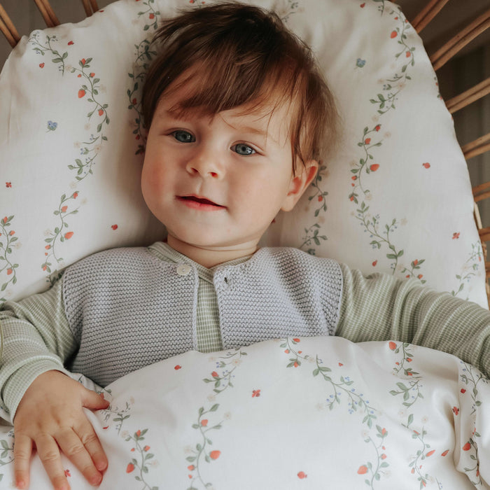 Botanical Berries Baby Duvet with boy laying with it in crib