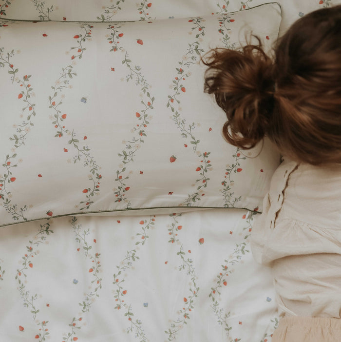 Botanical Berries Toddler Pillow with little girl laying on it