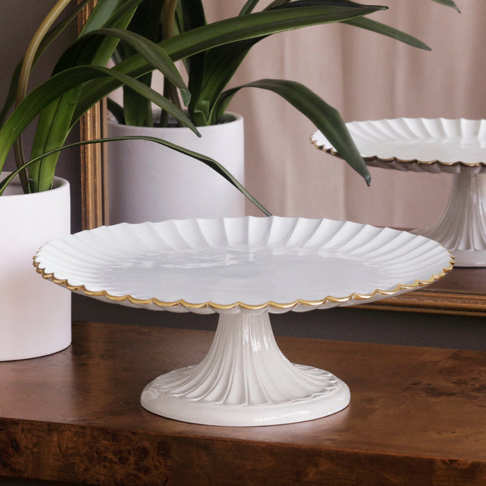 Beatriz Ball Encanto Vienna Pedestal Cake Plate — Empty beside a potted plant