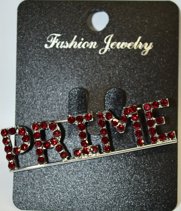 Jewelry card with a decorative brooch featuring red gemstones on a gray background.