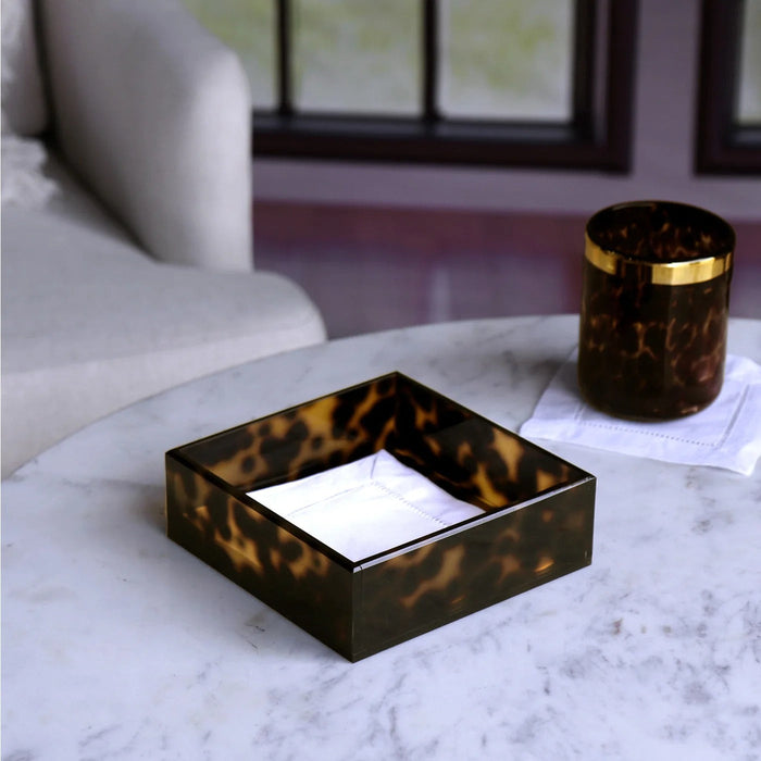 Beatriz Ball Vida Acrylic Tortoise Beverage Napkin Holder — Holding napkins beside a separate tortoise-pattern tumbler